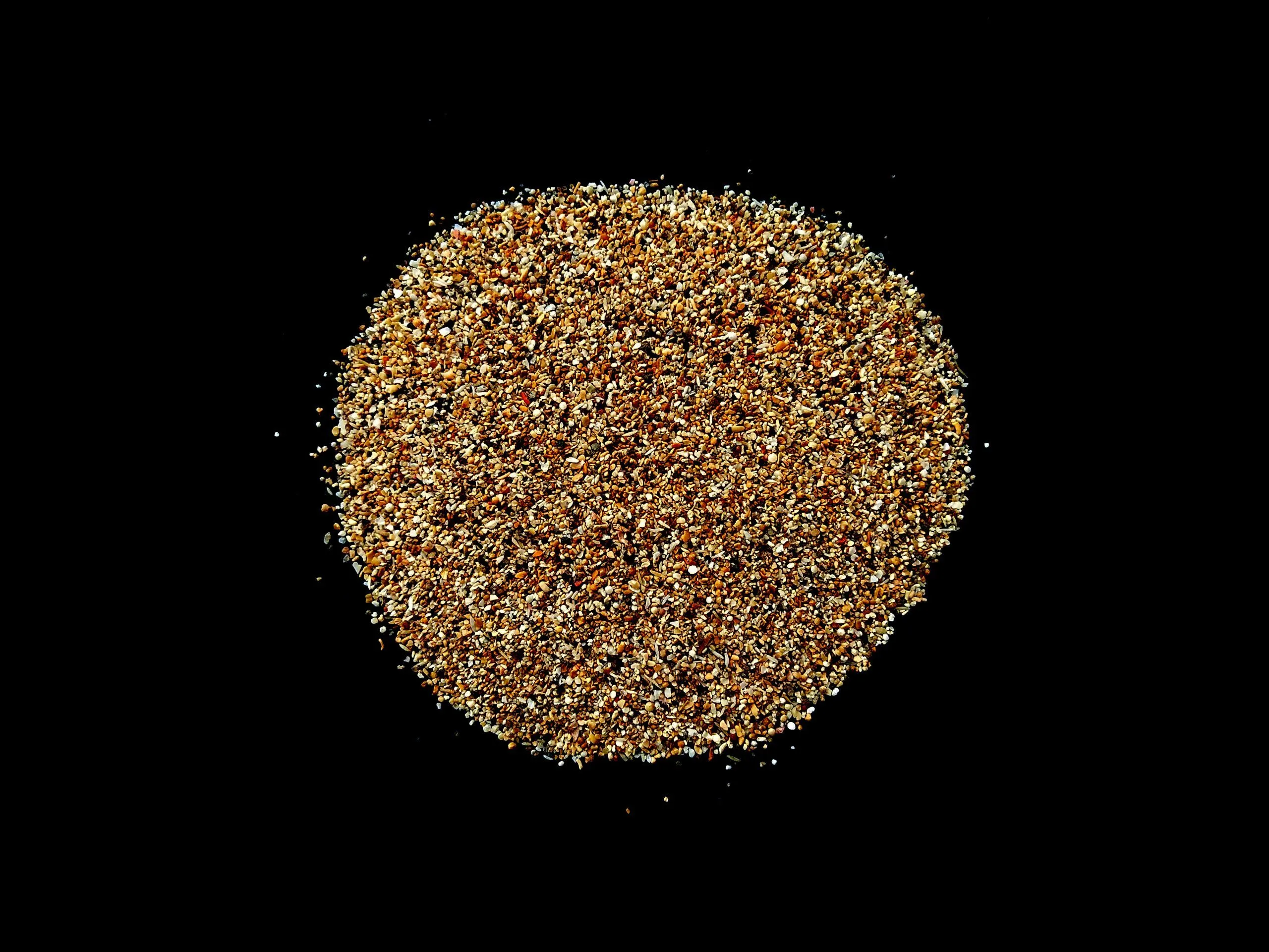 Abstract sand cloud and Golden sand explosion isolated on black background. Pile sand beach isolated on black background. Sand dunes isolated on black background.